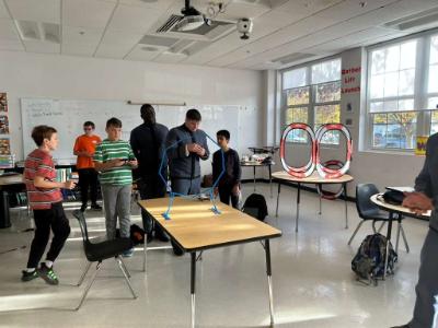 Cadets work with students in the classroom.